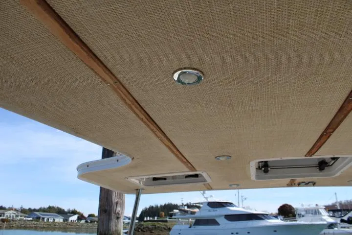Slide: The Image of 2019 Ranger Tugs R-31 CB boat ceiling with recessed lighting and wood accents. - 26