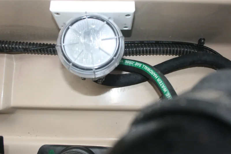 Slide: The Image of Close-up of 2019 Ranger Tugs R-31 CB engine compartment with wiring and hoses. - 37