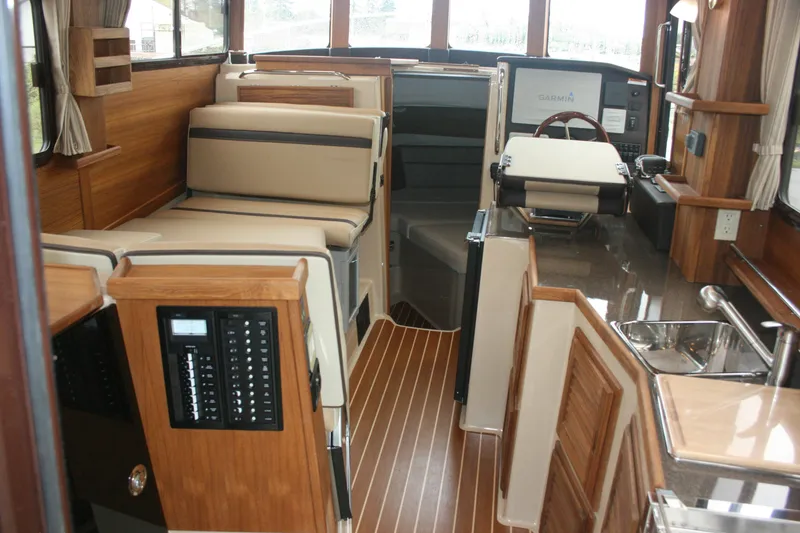 Slide: The Image of Interior of 2019 Ranger Tugs R-31 CB boat with wood accents and modern navigation equipment. - 43