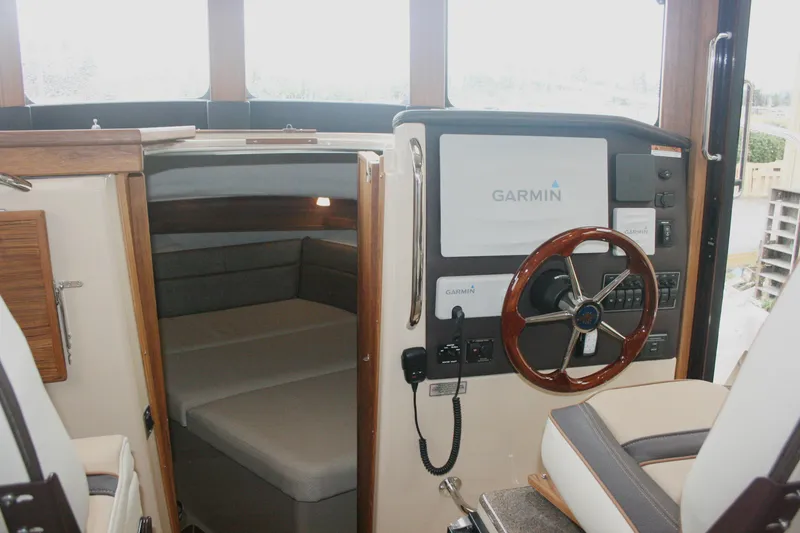 Slide: The Image of 2019 Ranger Tugs R-31 CB interior with Garmin navigation system and cozy cabin space. - 44