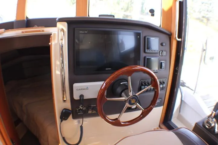 Slide: The Image of 2019 Ranger Tugs R-31 CB helm with Garmin navigation system and wooden steering wheel. - 45