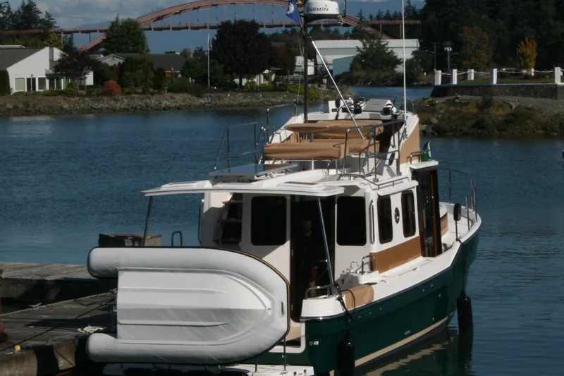 Slide: The Image of 2019 Ranger Tugs R-31 CB docked by a scenic waterfront. - 5