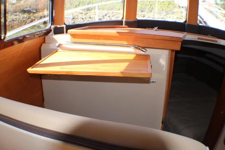 Slide: The Image of Interior of 2019 Ranger Tugs R-31 CB, featuring wooden cabinetry and seating. - 51