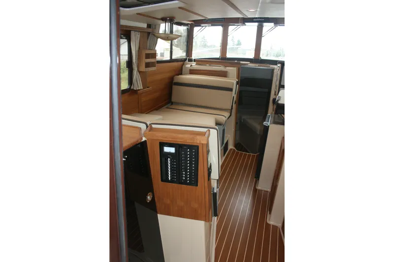 Slide: The Image of Interior of 2019 Ranger Tugs R-31 CB, featuring wood accents and comfortable seating. - 54