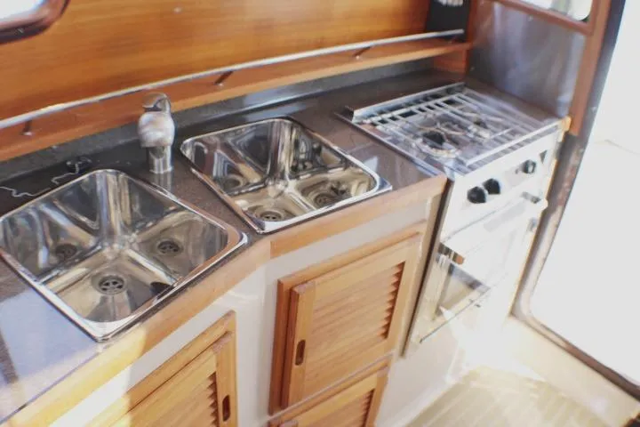 Slide: The Image of 2019 Ranger Tugs R-31 CB kitchen with dual sinks and stove. - 59