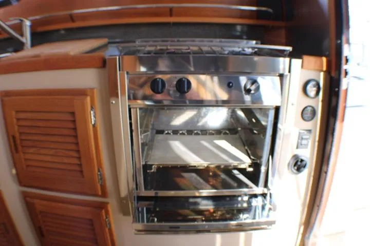 Slide: The Image of Stainless steel oven in 2019 Ranger Tugs R-31 CB boat kitchen. - 61