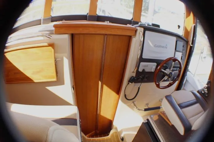 Slide: The Image of 2019 Ranger Tugs R-31 CB helm with wooden accents and Garmin navigation system. - 63