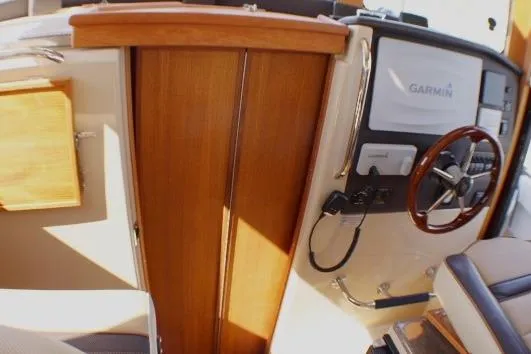 Slide: The Image of 2019 Ranger Tugs R-31 CB helm with Garmin navigation and wooden accents. - 64