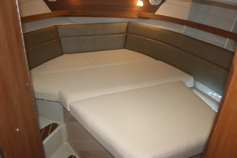 Slide: The Image of 2019 Ranger Tugs R-31 CB interior cabin with cushioned seating and warm lighting. - 65