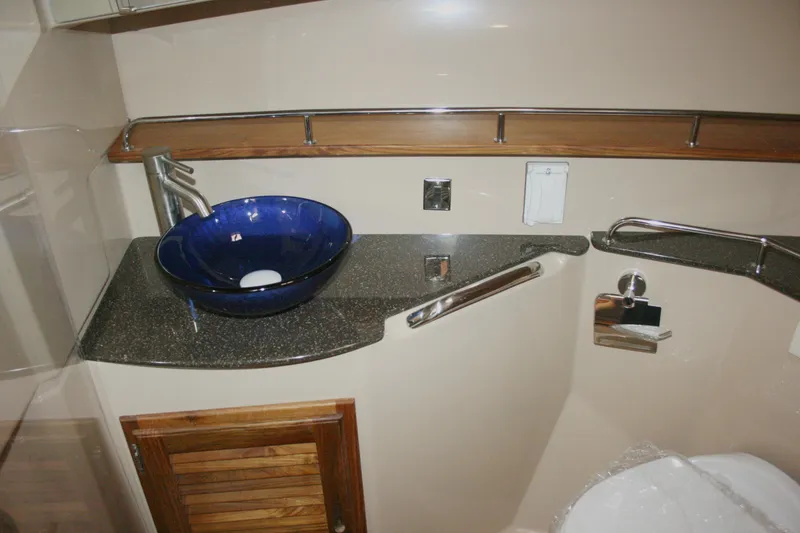 Slide: The Image of 2019 Ranger Tugs R-31 CB bathroom with blue vessel sink and modern fixtures. - 66