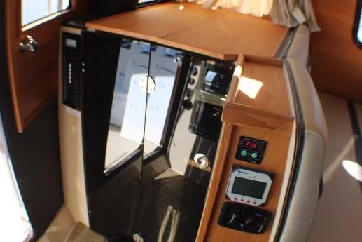 Slide: The Image of Interior of 2019 Ranger Tugs R-31 CB with wooden cabinetry and control panels. - 68