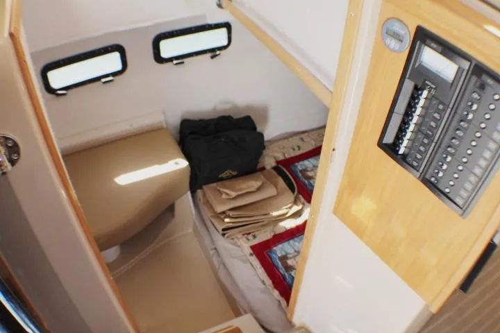 Slide: The Image of 2019 Ranger Tugs R-31 CB cabin interior with bed, windows, and control panel. - 69