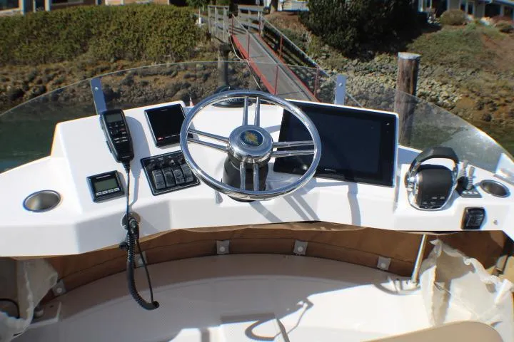 Slide: The Image of 2019 Ranger Tugs R-31 CB helm with steering wheel and navigation equipment. - 7