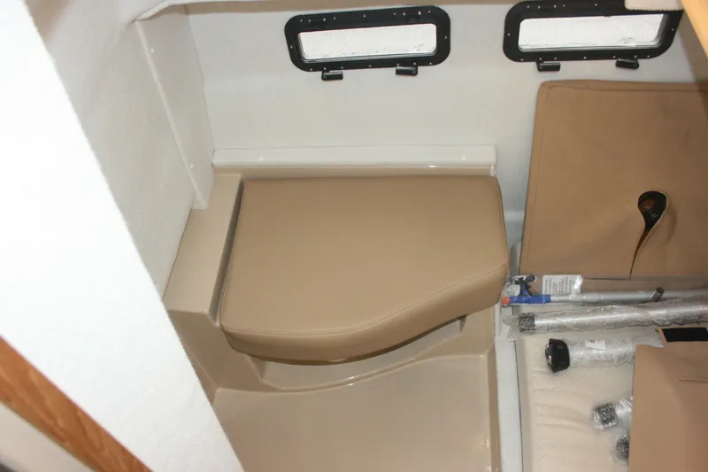 Slide: The Image of 2019 Ranger Tugs R-31 CB interior cabin with beige seating and storage compartments. - 71