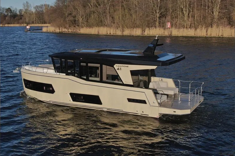 Slide: The Image of 2026 Cobra Yachts Campione 41 Coupe cruising on a serene lake. - 3