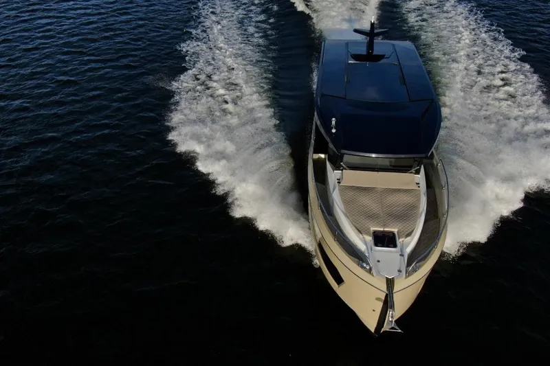 Slide: The Image of 2026 Cobra Yachts Campione 41 Coupe cruising on open water, aerial view. - 5