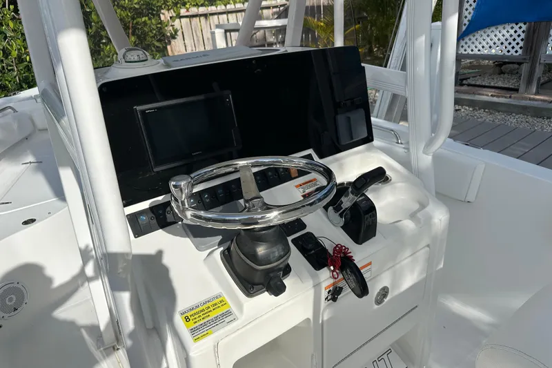 Slide: The Image of 2018 Sea Hunt Ultra 234 boat console with steering wheel and navigation controls. - 18
