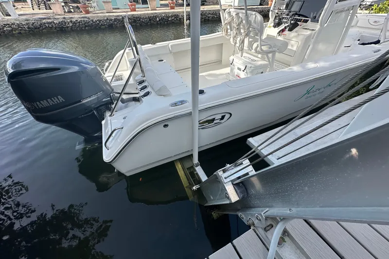 Slide: The Image of 2018 Sea Hunt Ultra 234 boat docked with Yamaha outboard motor. - 9
