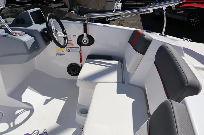Slide: The Image of 2023 White River Tahoe boat interior with steering wheel and cushioned seating. - 10