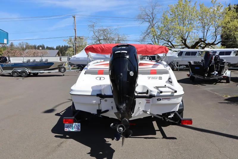 Slide: The Image of 2023 White River Tahoe boat with outboard motor in a sunny parking lot. - 4