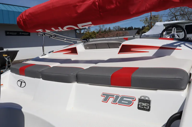 Slide: The Image of 2023 White River Tahoe T16 boat with red and gray seating, outdoor display. - 6