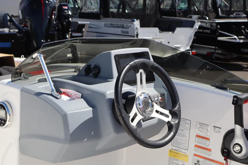 Slide: The Image of 2023 White River Tahoe boat dashboard with steering wheel and control panel. - 7
