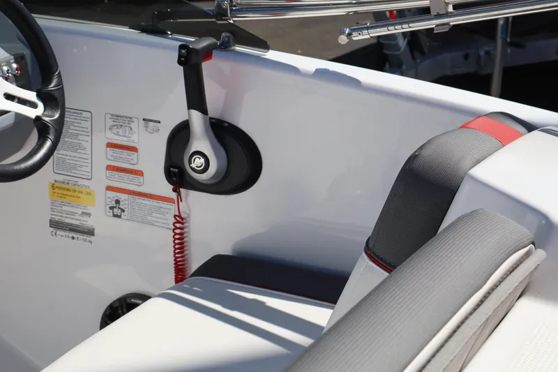 Slide: The Image of Interior of 2023 White River Tahoe boat showing steering wheel and seating area. - 8