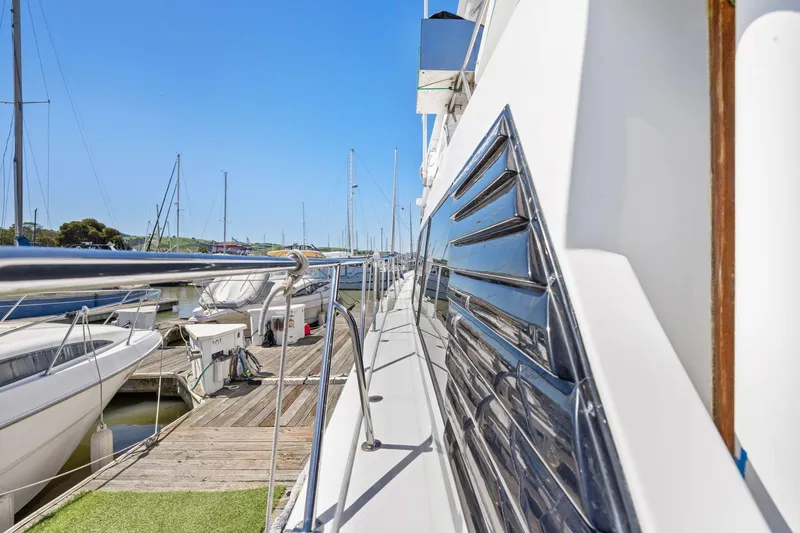 Slide: The Image of Side view of a 1991 Ocean Alexander 520 Pilothouse yacht docked at a marina. - 11