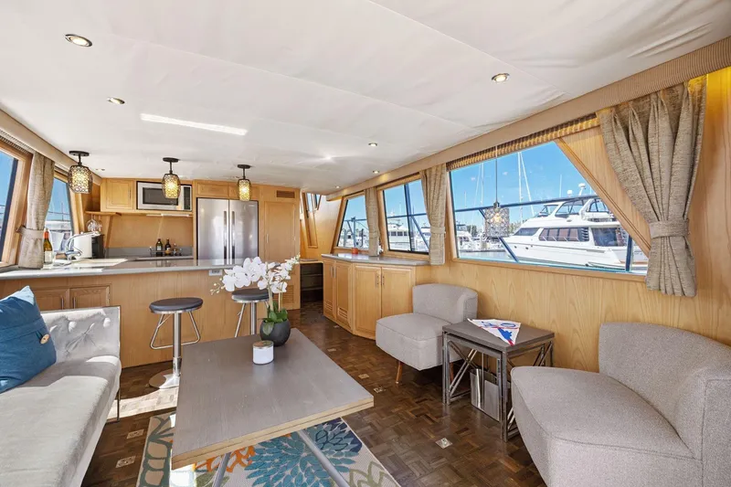Slide: The Image of Luxurious interior of 1991 Ocean Alexander 520 Pilothouse yacht with modern furnishings and large windows. - 13