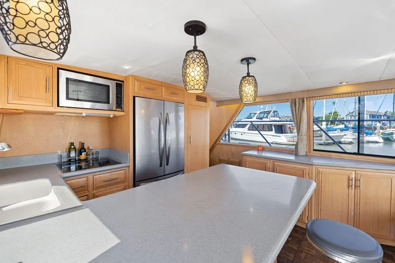Slide: The Image of Luxurious kitchen interior of 1991 Ocean Alexander 520 Pilothouse yacht with marina view. - 16