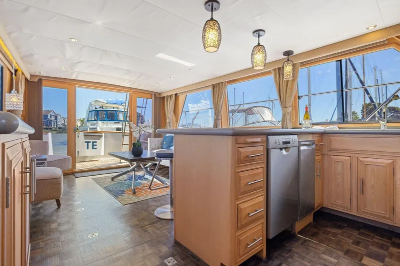 Slide: The Image of Luxurious interior of 1991 Ocean Alexander 520 Pilothouse yacht with modern kitchen and seating area. - 18