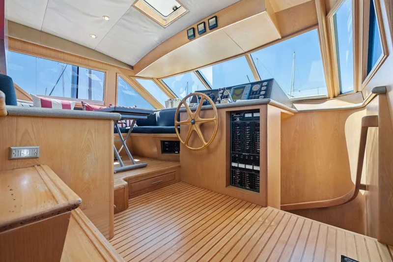 Slide: The Image of Pilothouse interior of 1991 Ocean Alexander 520, featuring wooden helm and navigation controls. - 19