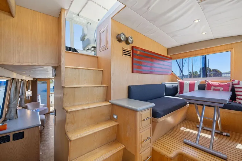 Slide: The Image of Interior of 1991 Ocean Alexander 520 Pilothouse with wooden stairs and cozy seating area. - 21