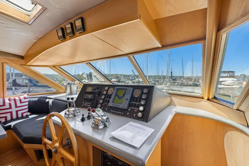 Slide: The Image of Pilothouse interior of 1991 Ocean Alexander 520, featuring navigation controls and panoramic windows. - 23