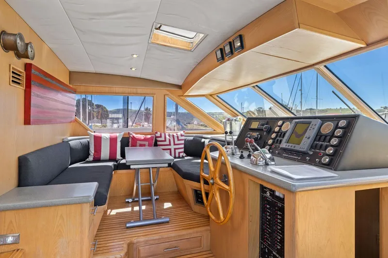Slide: The Image of Luxurious 1991 Ocean Alexander 520 Pilothouse interior with helm, seating, and navigation equipment. - 24