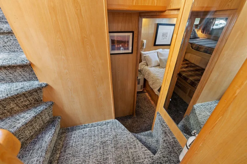 Slide: The Image of Interior of 1991 Ocean Alexander 520 Pilothouse with carpeted stairs and cozy cabin. - 26