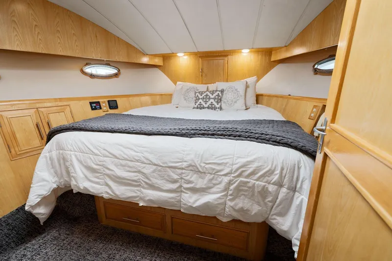 Slide: The Image of Luxurious bedroom interior of 1991 Ocean Alexander 520 Pilothouse yacht with cozy bedding. - 28
