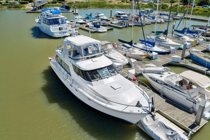 Slide: The Image of 1991 Ocean Alexander 520 Pilothouse yacht docked at a marina with other boats. - 3