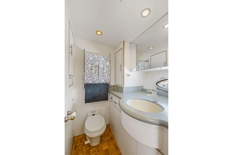 Slide: The Image of Bathroom interior of 1991 Ocean Alexander 520 Pilothouse yacht, featuring modern fixtures and wood flooring. - 30