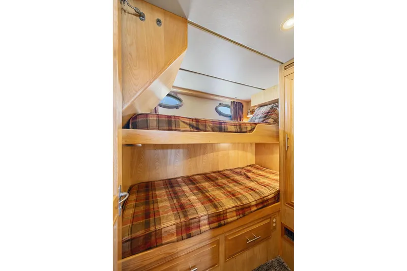 Slide: The Image of Cozy bunk beds in 1991 Ocean Alexander 520 Pilothouse cabin with plaid bedding. - 35