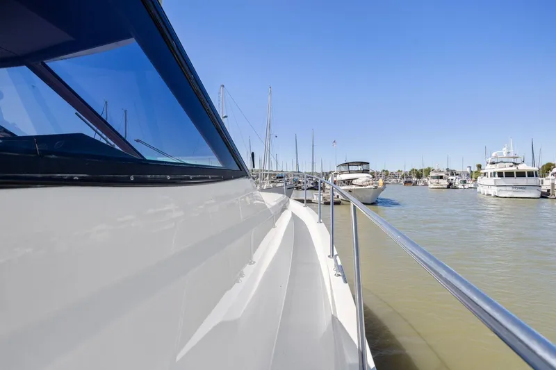 Slide: The Image of Side view of a 1991 Ocean Alexander 520 Pilothouse yacht docked in a marina. - 36