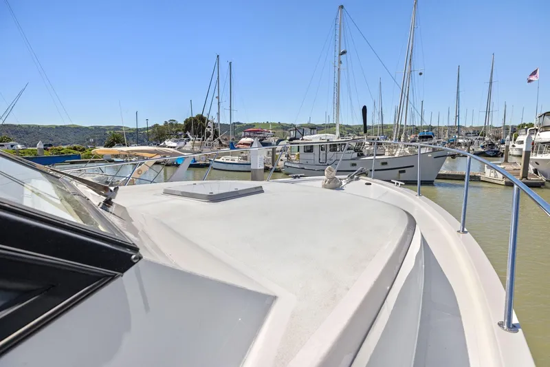 Slide: The Image of 1991 Ocean Alexander 520 Pilothouse yacht docked in a marina, surrounded by sailboats. - 37