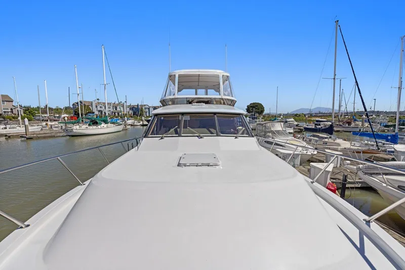Slide: The Image of 1991 Ocean Alexander 520 Pilothouse yacht docked in a marina, surrounded by sailboats. - 39