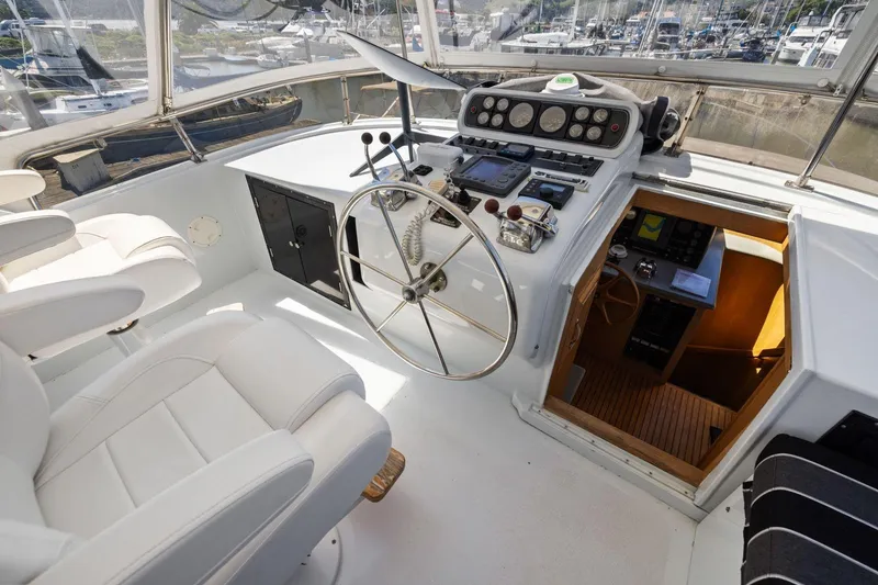 Slide: The Image of Pilothouse interior of 1991 Ocean Alexander 520, featuring steering wheel and navigation controls. - 41
