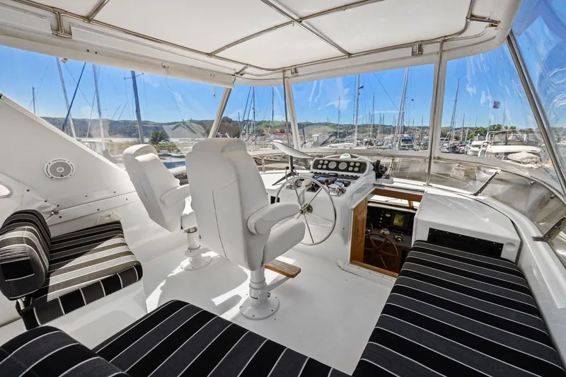 Slide: The Image of Interior view of 1991 Ocean Alexander 520 Pilothouse yacht cockpit with striped seating. - 43