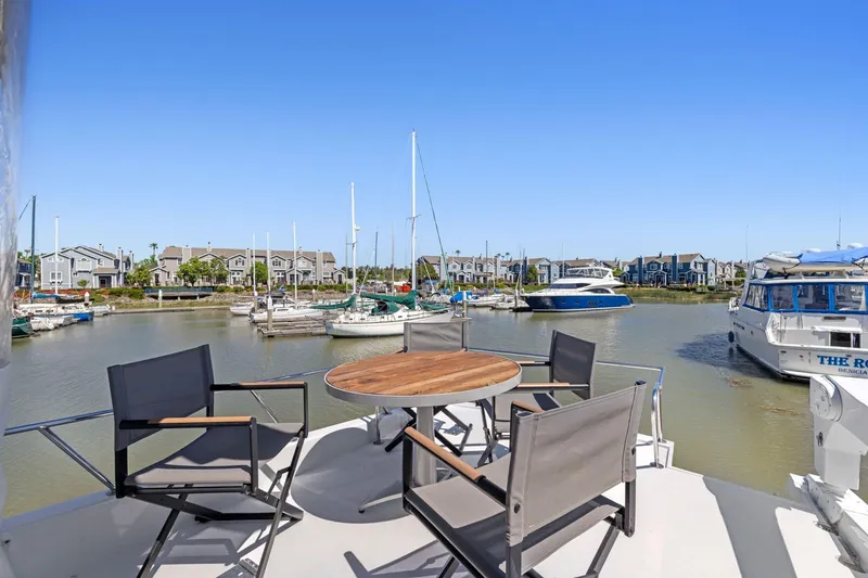 Slide: The Image of Ocean Alexander 520 Pilothouse yacht deck with chairs, table, and marina view, 1991 model. - 45