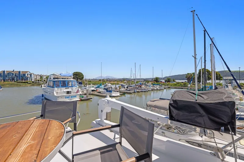 Slide: The Image of Ocean Alexander 520 Pilothouse 1991 docked in a scenic marina setting. - 46