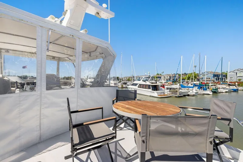 Slide: The Image of Ocean Alexander 520 Pilothouse 1991 yacht with outdoor seating, docked at a marina. - 47