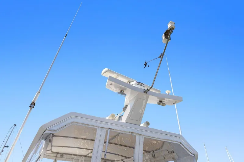 Slide: The Image of Radar and antennas on 1991 Ocean Alexander 520 Pilothouse against clear blue sky. - 48