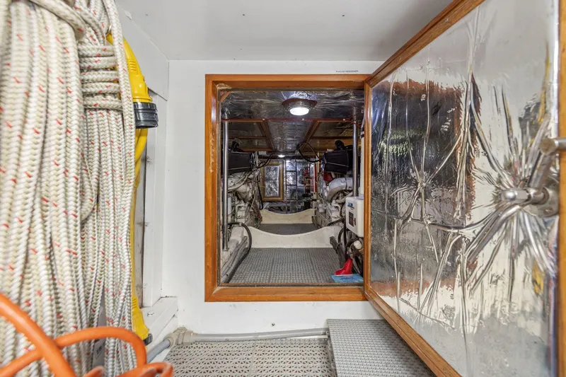 Slide: The Image of Engine room of 1991 Ocean Alexander 520 Pilothouse yacht with visible equipment and insulation. - 49